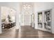 Bright entryway with hardwood floors, high ceilings, designer light fixtures, and double French doors at 2505 E Lehi Rd # 16, Mesa, AZ 85213