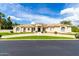 Beige home with a tile roof, curved driveway, and well-maintained desert landscaping at 2505 E Lehi Rd # 16, Mesa, AZ 85213
