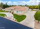 Beige home with a curved driveway, desert landscaping, and a tile roof at 2505 E Lehi Rd # 16, Mesa, AZ 85213