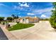 Expansive beige home featuring lush lawn and a tile roof under a beautiful sky at 2505 E Lehi Rd # 16, Mesa, AZ 85213