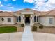 Elegant beige home with a tile roof, featuring desert landscaping and a grand entrance at 2505 E Lehi Rd # 16, Mesa, AZ 85213
