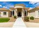 Elegant home featuring a circular entryway, beautiful landscaping, and a well-manicured lawn at 2505 E Lehi Rd # 16, Mesa, AZ 85213