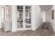 Hallway leading to office through french doors, with hardwood floors and neutral color palette at 2505 E Lehi Rd # 16, Mesa, AZ 85213