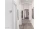 Bright hallway with wood flooring and neutral decor leading to the rest of the house at 2505 E Lehi Rd # 16, Mesa, AZ 85213