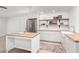 Modern kitchen with stainless steel appliances, light wood countertops, and a matching kitchen island at 2505 E Lehi Rd # 16, Mesa, AZ 85213