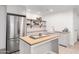 Finished basement kitchenette with stainless steel appliances, island, and floating shelves at 2505 E Lehi Rd # 16, Mesa, AZ 85213