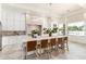 Bright, open kitchen features an island with counter seating, modern lighting, and stainless steel appliances at 2505 E Lehi Rd # 16, Mesa, AZ 85213