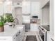 Bright kitchen with stainless steel appliances, white cabinetry, island sink, and designer pendant lighting at 2505 E Lehi Rd # 16, Mesa, AZ 85213