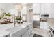 Open-concept kitchen featuring a large island, stainless steel refrigerator, and ample cabinet space at 2505 E Lehi Rd # 16, Mesa, AZ 85213