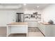 Finished basement kitchenette with stainless steel appliances, island, and floating shelves at 2505 E Lehi Rd # 16, Mesa, AZ 85213