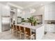 Modern kitchen with white cabinetry, stainless steel appliances, tile backsplash, and large island with seating at 2505 E Lehi Rd # 16, Mesa, AZ 85213