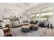 Open-concept living room with modern furniture, a view of the pool, and access to the kitchen at 2505 E Lehi Rd # 16, Mesa, AZ 85213