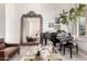 Cozy living room featuring a grand piano, decorative mirror, and stylish furniture at 2505 E Lehi Rd # 16, Mesa, AZ 85213