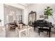 Stylish living room with a grand piano, decorative mirror, and comfortable armchairs at 2505 E Lehi Rd # 16, Mesa, AZ 85213