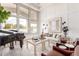 Well-lit living room featuring a grand piano, large windows, and comfortable seating at 2505 E Lehi Rd # 16, Mesa, AZ 85213