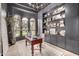 Stylish home office with built-in bookshelves, modern chandelier, and views of the front yard at 2505 E Lehi Rd # 16, Mesa, AZ 85213