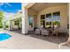Covered patio features seating, multiple windows, and tile flooring next to a pool area at 2505 E Lehi Rd # 16, Mesa, AZ 85213