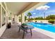 Expansive covered patio overlooking a backyard featuring a sparkling blue pool and lush landscaping at 2505 E Lehi Rd # 16, Mesa, AZ 85213
