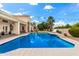 Sparkling pool with blue tiles, patio area, manicured landscaping, and string lights at 2505 E Lehi Rd # 16, Mesa, AZ 85213