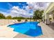 Inviting backyard pool featuring blue tile, tiled patio, and lush greenery at 2505 E Lehi Rd # 16, Mesa, AZ 85213