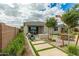 Beautiful backyard patio with a fire pit, outdoor seating, and manicured landscaping at 2637 N 195Th Dr, Buckeye, AZ 85396