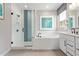 Bathroom features a separate glass enclosed shower, soaking tub, dual sinks, white cabinets and gray tile flooring at 2637 N 195Th Dr, Buckeye, AZ 85396