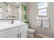 Well-lit bathroom featuring a white vanity, framed mirror, and a walk-in shower at 2637 N 195Th Dr, Buckeye, AZ 85396