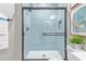 Beautiful bathroom with a sleek glass shower enclosure and hexagonal tiling at 2637 N 195Th Dr, Buckeye, AZ 85396