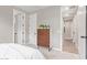A bedroom with a designer chest of drawers and access to the hall and bathroom at 2637 N 195Th Dr, Buckeye, AZ 85396
