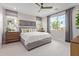 A bedroom with neutral décor features a large window and wood furniture at 2637 N 195Th Dr, Buckeye, AZ 85396