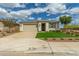 Inviting single-story home featuring a well-manicured lawn and a spacious two-car garage at 2637 N 195Th Dr, Buckeye, AZ 85396