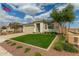 Inviting home with a well-maintained lawn, stone accents, and an American flag waving proudly at 2637 N 195Th Dr, Buckeye, AZ 85396