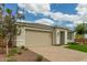 A well-manicured lawn and stone facade enhance the curb appeal of this beautiful home at 2637 N 195Th Dr, Buckeye, AZ 85396