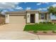 Inviting single-story home with a brick-paved driveway, lush lawn, and stone-accented facade, perfect for curb appeal at 2637 N 195Th Dr, Buckeye, AZ 85396