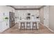 Modern kitchen with white cabinets, stainless steel appliances, and a central island with stylish seating at 2637 N 195Th Dr, Buckeye, AZ 85396
