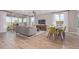 Spacious living room with a modern layout, connecting to the dining area and featuring wood-look flooring at 2637 N 195Th Dr, Buckeye, AZ 85396