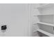 A pantry with a door and white shelving, providing ample storage space at 2637 N 195Th Dr, Buckeye, AZ 85396