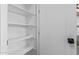 Spacious white pantry with shelving and door offers ample storage at 2637 N 195Th Dr, Buckeye, AZ 85396