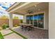 Covered patio with outdoor dining area seamlessly connects indoor and outdoor spaces at 2637 N 195Th Dr, Buckeye, AZ 85396