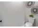 A simple powder room with a toilet and a decorative plant at 2637 N 195Th Dr, Buckeye, AZ 85396