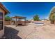 An outdoor kitchen and in-ground pool in this backyard at 2794 E Cowboy Cove Trl, San Tan Valley, AZ 85143