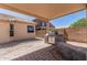 Outdoor kitchen with built in grill and fenced yard with patio at 2794 E Cowboy Cove Trl, San Tan Valley, AZ 85143