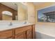 Bathroom showcasing a dual sink vanity and a large soaking tub at 2794 E Cowboy Cove Trl, San Tan Valley, AZ 85143
