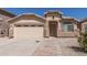 Inviting single-story home featuring a two-car garage and low-maintenance desert landscaping at 2794 E Cowboy Cove Trl, San Tan Valley, AZ 85143