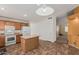 A kitchen offers a center island, wood cabinetry, white appliances, and easy access to living space at 2794 E Cowboy Cove Trl, San Tan Valley, AZ 85143