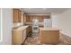 Open kitchen featuring tiled floors, center island, wood cabinetry and modern appliances at 2794 E Cowboy Cove Trl, San Tan Valley, AZ 85143