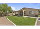 An inviting backyard with artificial turf, a covered patio, and block walls for privacy at 2932 N 115Th Ln, Avondale, AZ 85392