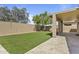 Inviting backyard with a covered patio, artificial grass, and a well-maintained block fence at 2932 N 115Th Ln, Avondale, AZ 85392
