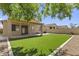 Spacious backyard features artificial turf, a covered patio, and secure fencing, perfect for outdoor enjoyment at 2932 N 115Th Ln, Avondale, AZ 85392