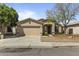 Charming single-story home with a well-maintained lawn, a two-car garage, and desert landscaping at 2932 N 115Th Ln, Avondale, AZ 85392